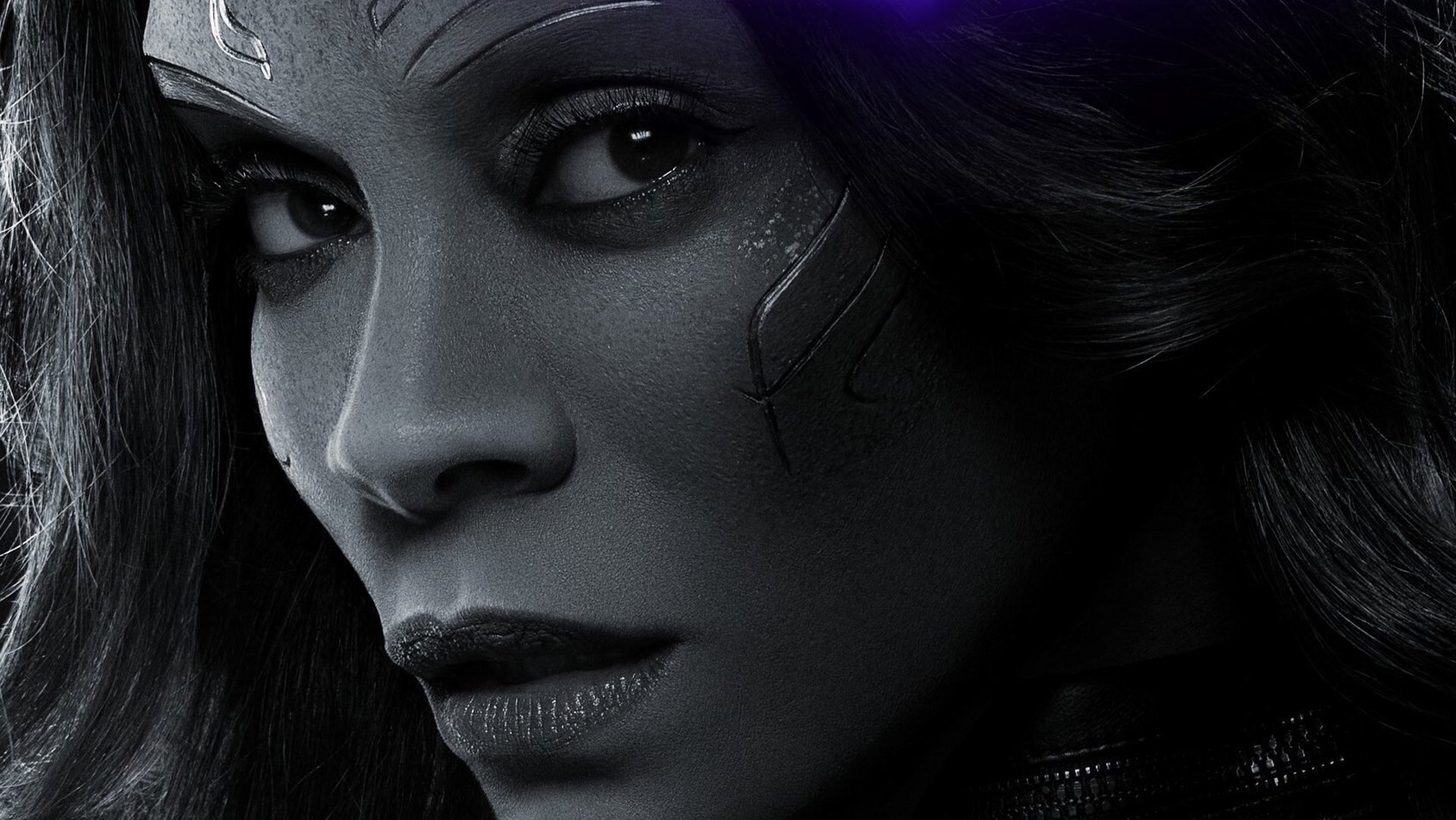 HD desktop wallpaper featuring Zoe Saldana as Gamora from Avengers: Endgame, showcasing a close-up of her face with a serious expression and intricate facial markings.