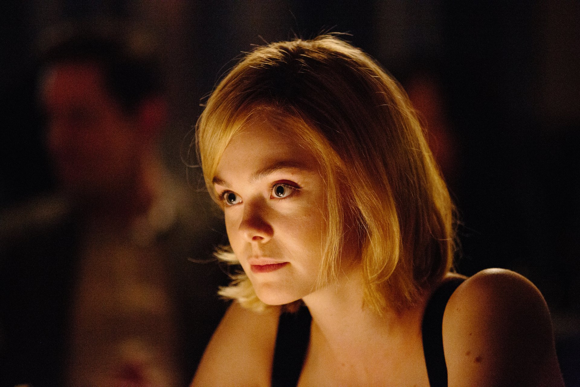 Close-up of blonde celebrity Elle Fanning in warm lighting, captured in high resolution for a 4K Ultra HD PC desktop wallpaper and background.