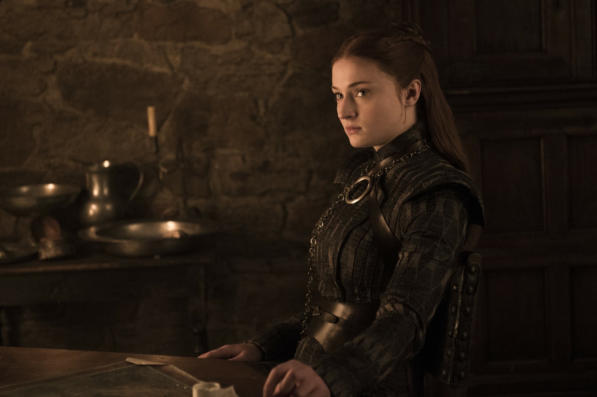 4K Ultra HD PC desktop wallpaper evoking Game of Thrones: woman in dark medieval armor seated at a candlelit stone table.