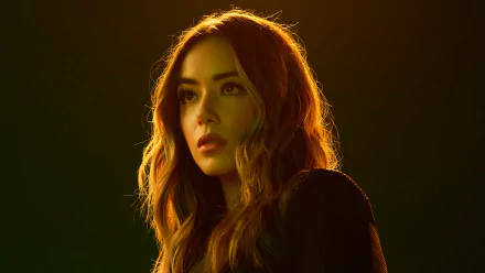 HD desktop wallpaper featuring Chloe Bennet from the TV show Agents of S.H.I.E.L.D., with warm lighting highlighting her face and hair.