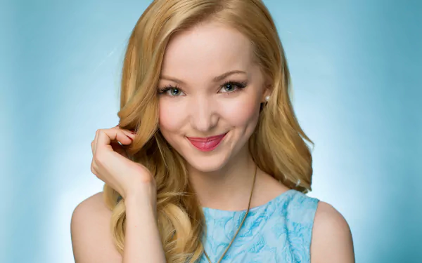 Close-up portrait of smiling blonde American actress Dove Cameron against a soft blue background, presented as a 4K Ultra HD desktop wallpaper.