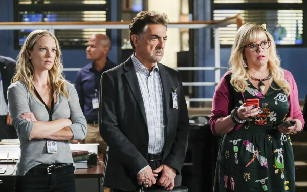 HD desktop wallpaper of Criminal Minds featuring three characters in an FBI office setting.