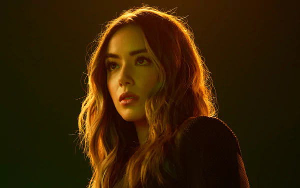 HD desktop wallpaper featuring Chloe Bennet from the TV show Agents of S.H.I.E.L.D., with warm lighting highlighting her face and hair.