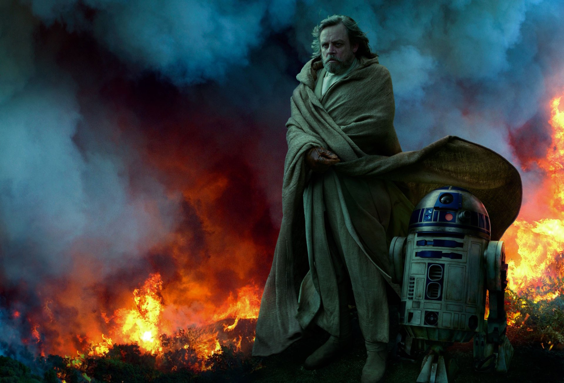 HD desktop wallpaper from Star Wars: The Rise of Skywalker featuring Luke Skywalker standing beside R2-D2 amidst a fiery, smoky background.