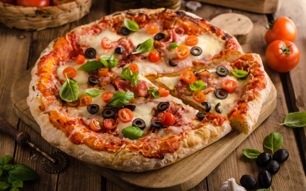 A vibrant still life of a freshly baked pizza topped with tomatoes, olives, garlic, and basil leaves, captured in stunning 4K Ultra HD for a PC desktop wallpaper.