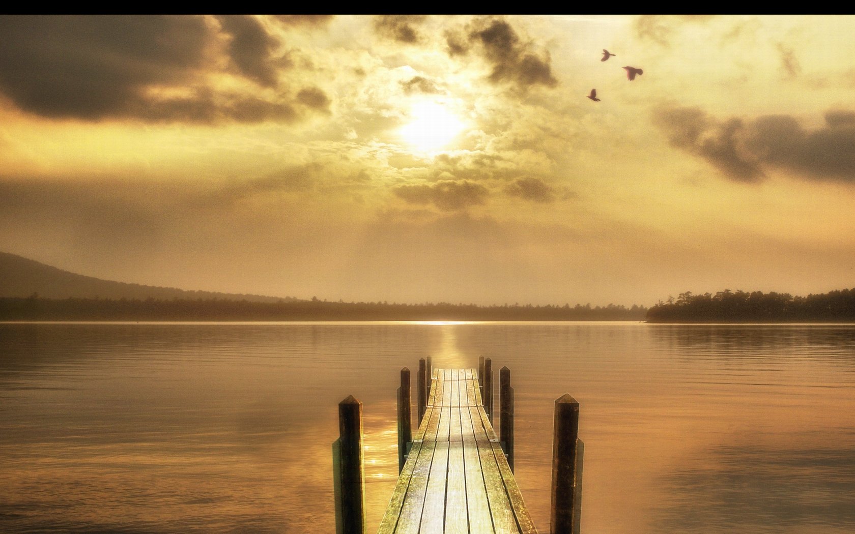 HD PC desktop wallpaper featuring a serene nature scene at sunset with a wooden dock extending into calm water under a golden sky and flying birds.