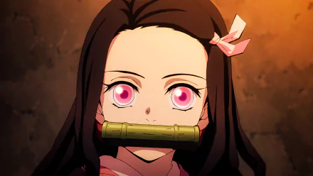 HD wallpaper featuring Nezuko Kamado from the anime Demon Slayer: Kimetsu no Yaiba, showing her pink eyes and signature bamboo muzzle, set against a warm-toned background.