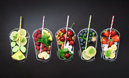 HD desktop wallpaper featuring six assorted fruit mix drinks in glasses, set against a dark background, includes lemons, cherries, berries, and pineapple.