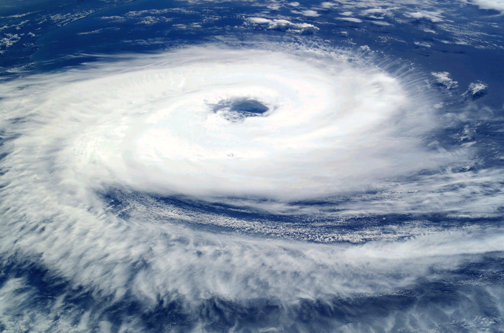 HD PC desktop wallpaper showing a powerful storm with a distinct eye, captured from above in a nature-themed image.