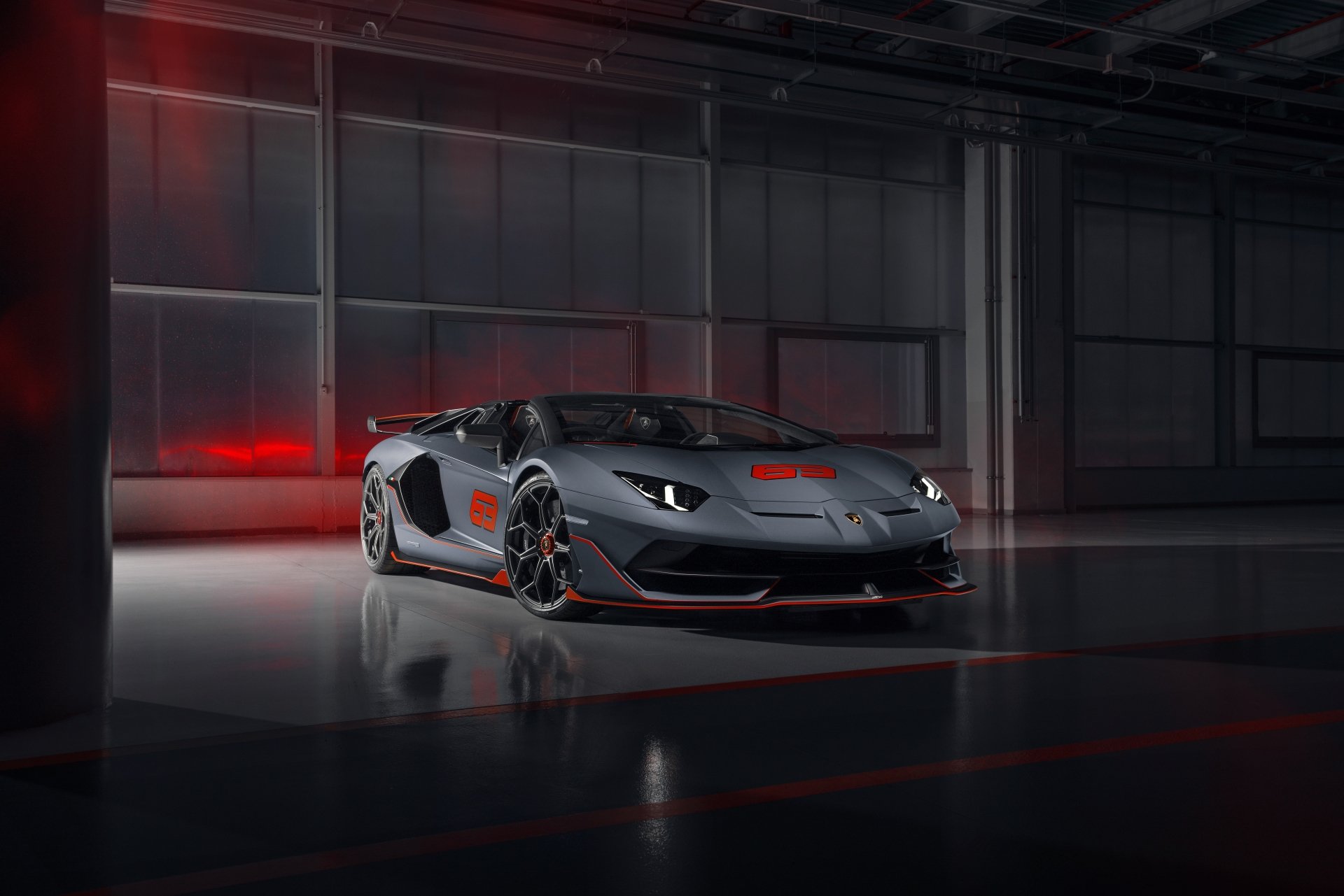 Silver Lamborghini Aventador SVJ supercar in a dim industrial garage with red accents — 8K Ultra HD PC desktop wallpaper/background
