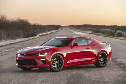 Red Hennessey Chevrolet Camaro SS HPE 600 muscle car parked on an open road at sunset, shown in 4K Ultra HD desktop wallpaper quality.