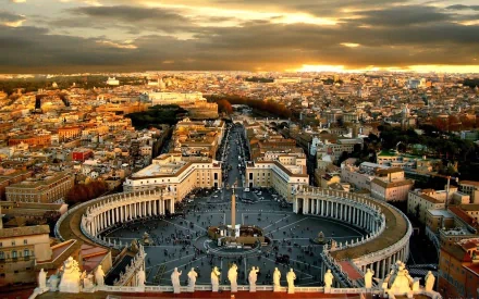 Sunset view over Vatican City in Rome, Italy, showcasing St. Peter's Square with the cityscape in the background. HD desktop wallpaper and background.