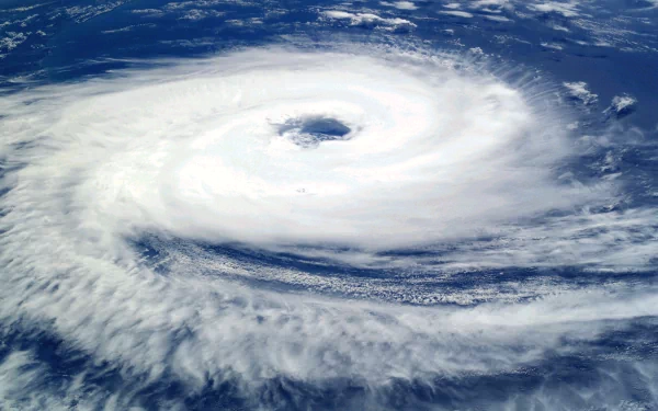 HD PC desktop wallpaper showing a powerful storm with a distinct eye, captured from above in a nature-themed image.