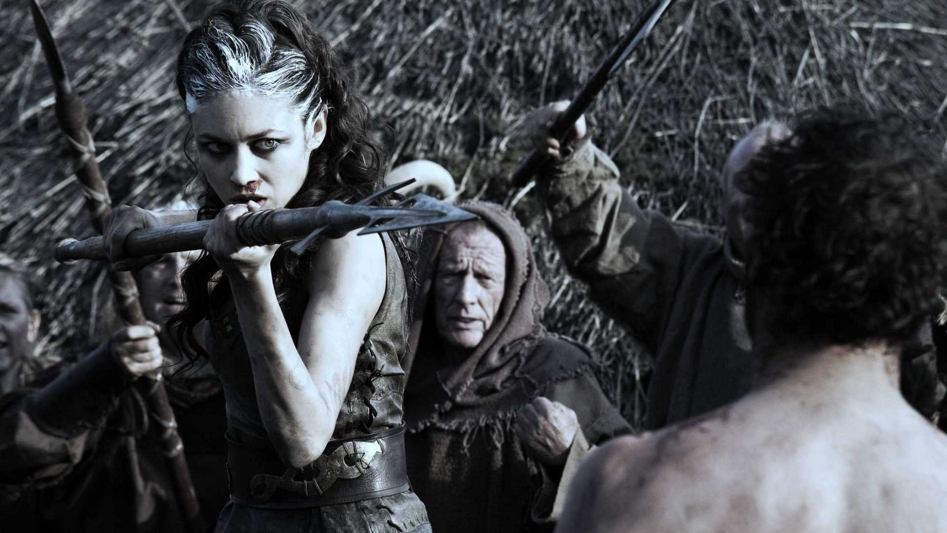 HD PC desktop wallpaper featuring a fierce Brigantian warrior from the movie Centurion, poised with a bow and arrow in a tense battle scene.