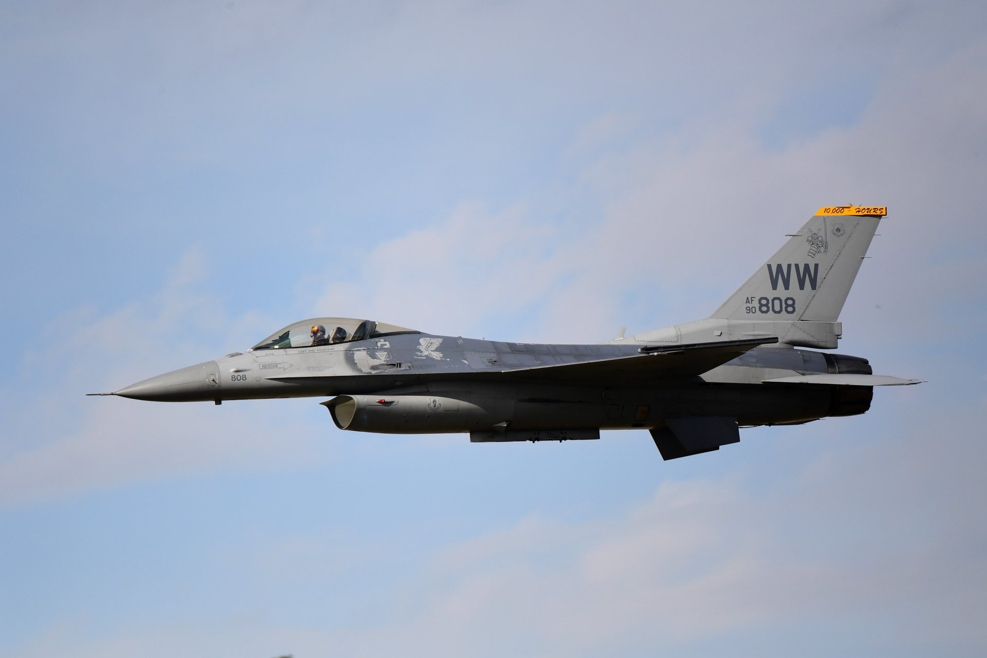 4K Ultra HD image of a General Dynamics F-16 Fighting Falcon jet fighter in flight, showcasing its sleek military warplane design against a clear sky.