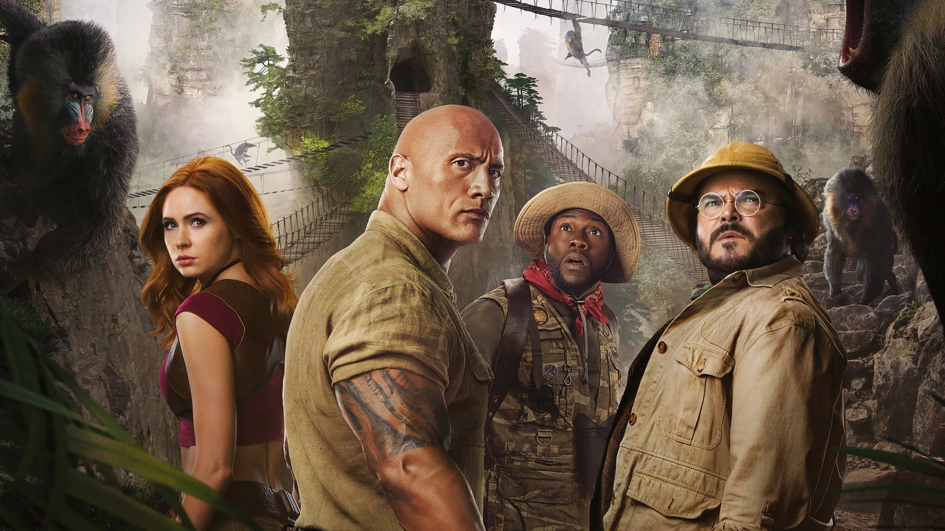HD PC desktop wallpaper featuring Karen Gillan, Dwayne Johnson, Kevin Hart, and Jack Black from the movie Jumanji: The Next Level in a jungle adventure scene.