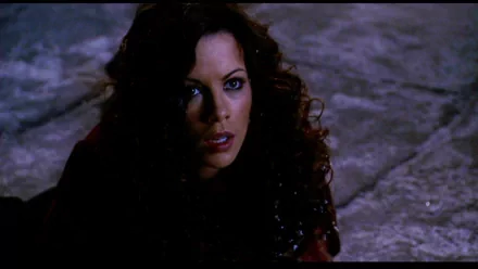 A close-up of Anna Valerious, portrayed by Kate Beckinsale in the movie Van Helsing, showcasing her intense expression against a dark, atmospheric background.