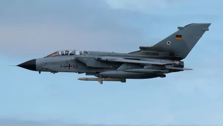 HD desktop wallpaper of a Panavia Tornado military jet fighter warplane soaring against a clear sky.