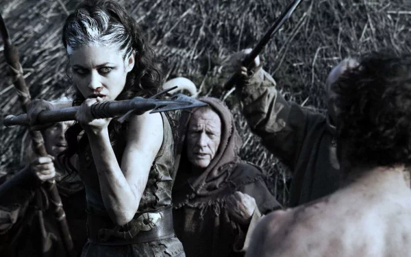 HD PC desktop wallpaper featuring a fierce Brigantian warrior from the movie Centurion, poised with a bow and arrow in a tense battle scene.