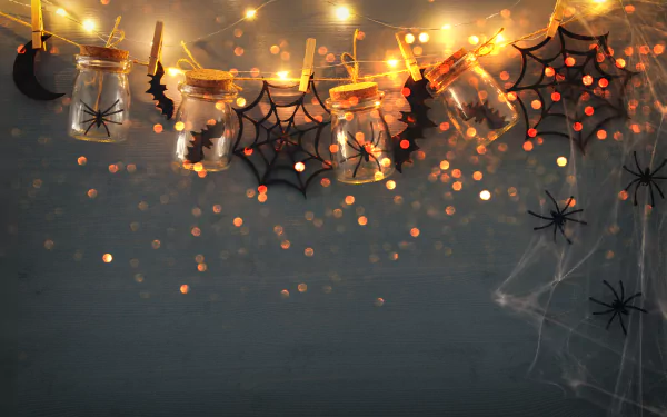 Halloween-themed 4K Ultra HD PC wallpaper featuring glowing jars, bats, spider webs, and festive lights against a dark, atmospheric background.