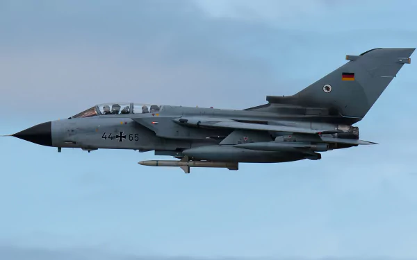 HD desktop wallpaper of a Panavia Tornado military jet fighter warplane soaring against a clear sky.