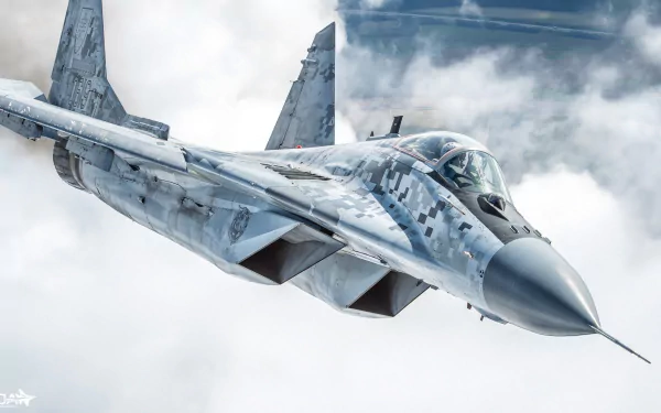 HD PC desktop wallpaper of a Mikoyan MiG-29 jet fighter — military warplane in blue-gray digital camouflage soaring above clouds, aircraft shown from a front-left angle.
