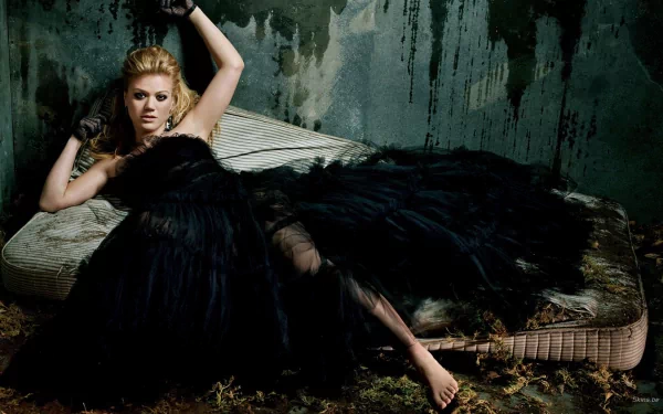 HD desktop wallpaper featuring singer Kelly Clarkson in a dramatic black gown, set against a dark, textured background, reflecting a moody music-themed atmosphere.
