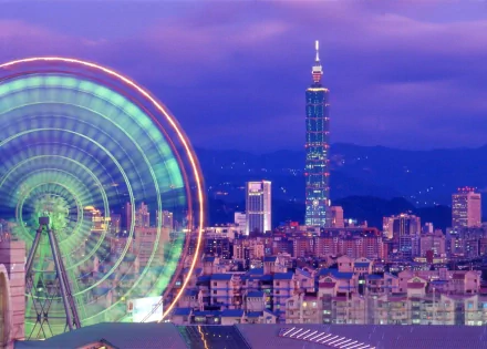 HD desktop wallpaper featuring a vibrant night view of Taipei cityscape with the illuminated Taipei 101 tower and a glowing Ferris wheel against a twilight sky.