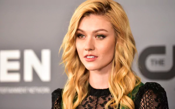 HD desktop wallpaper featuring American actress Katherine McNamara with green eyes and red hair against a neutral background.