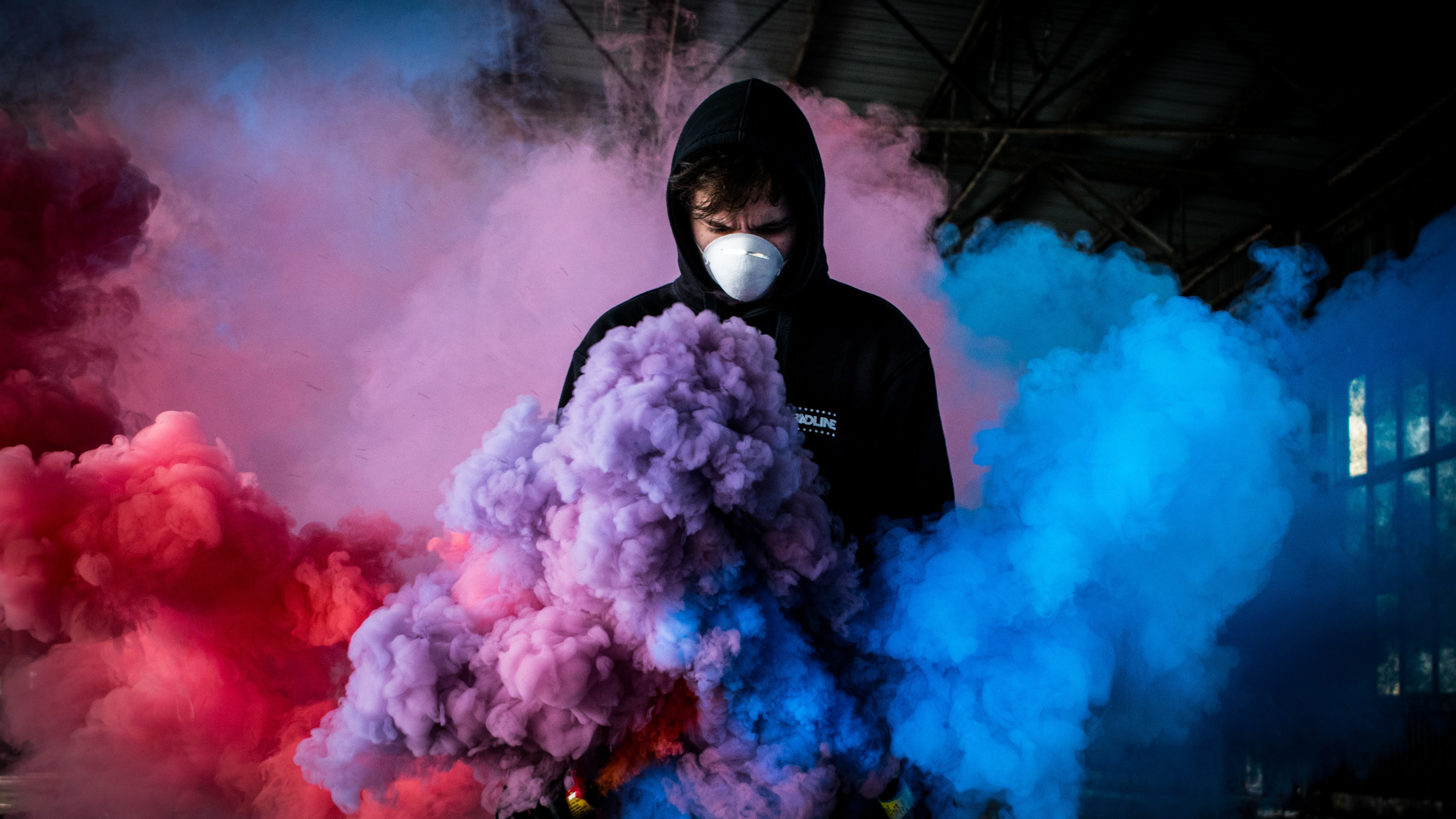 Masked Guy in Colorful Smoke by Kamil Feczko