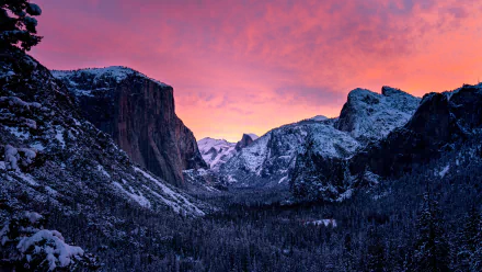Snow-covered mountains of Yosemite National Park under a vibrant pink and orange sunset sky, captured in stunning 8K Ultra HD for a PC desktop background.