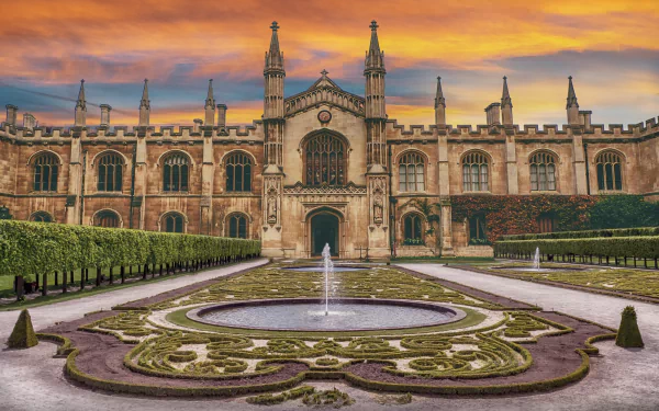 4K Ultra HD wallpaper of a majestic man-made palace with intricate architecture, a central fountain, and a colorful sunset sky in the background.