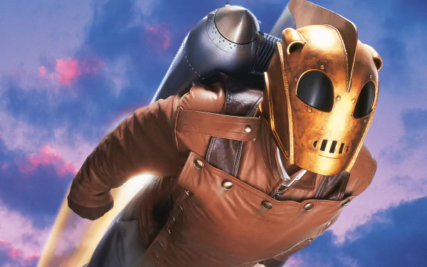 The Rocketeer from the movie, helmeted and leather-clad, rockets through a colorful cloudy sky — 4K Ultra HD PC desktop wallpaper/background.