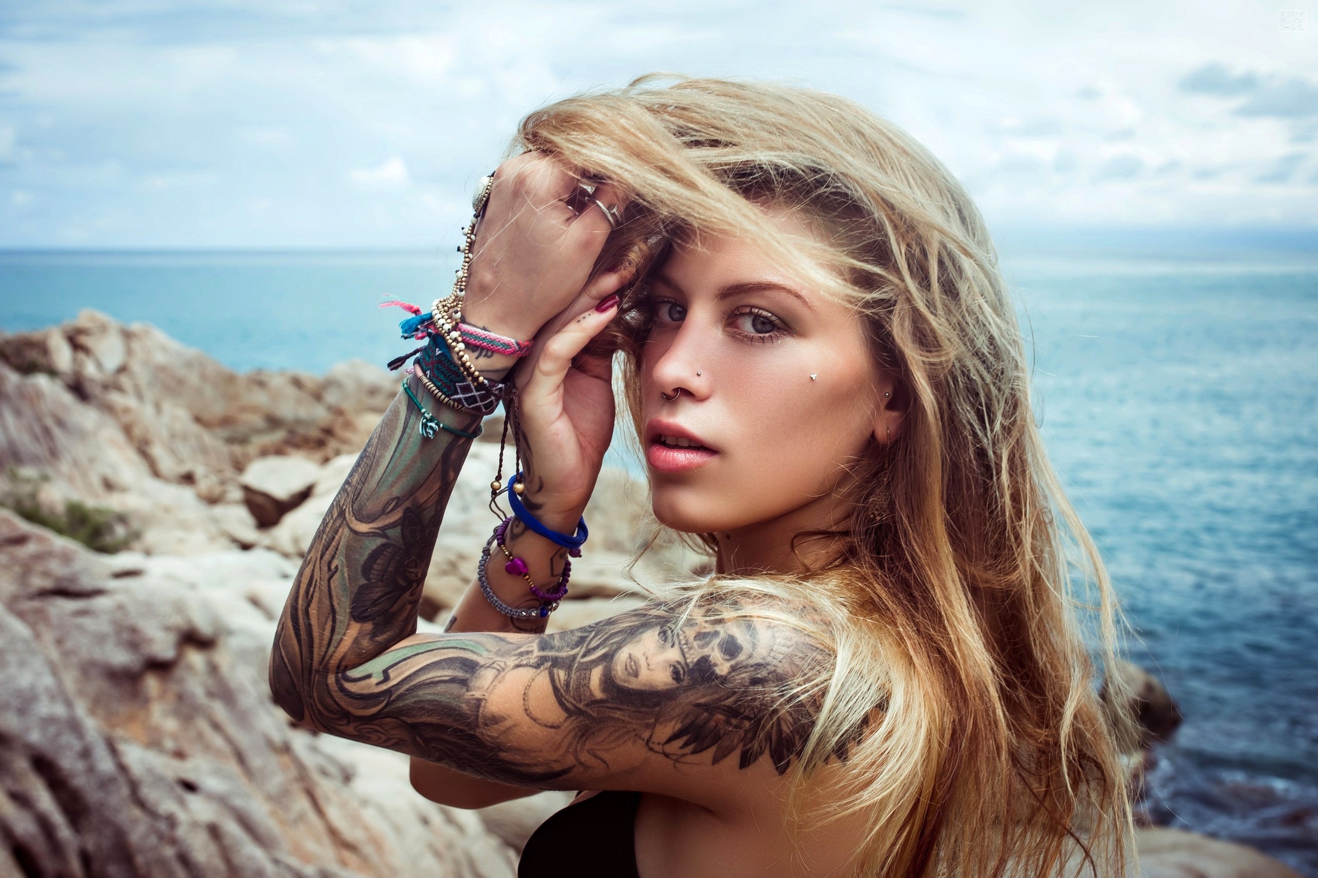 Beautiful young woman with tattoos on body, nose piercing and dreadlocks  listening to music indoors, closeup Stock Photo - Alamy