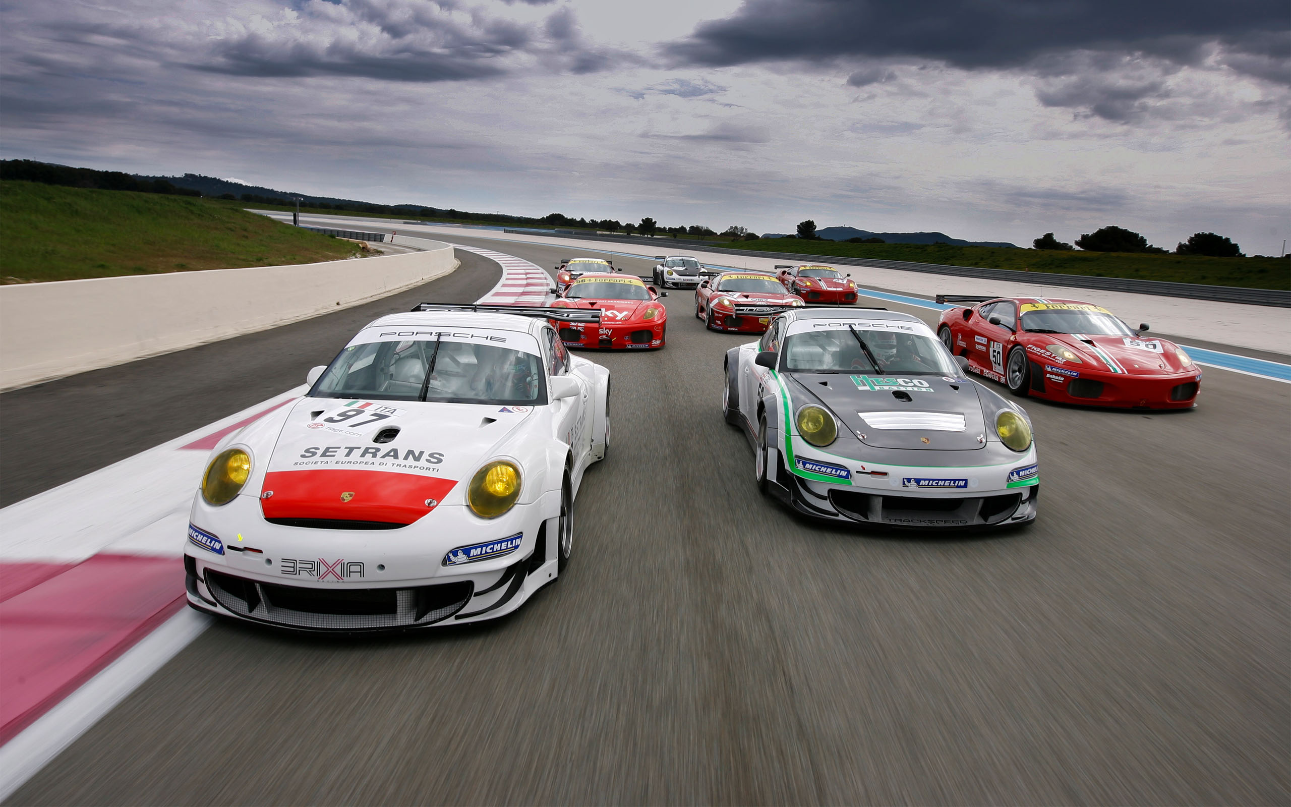 Porsche and Ferrari Grand Touring vehicles racing.
