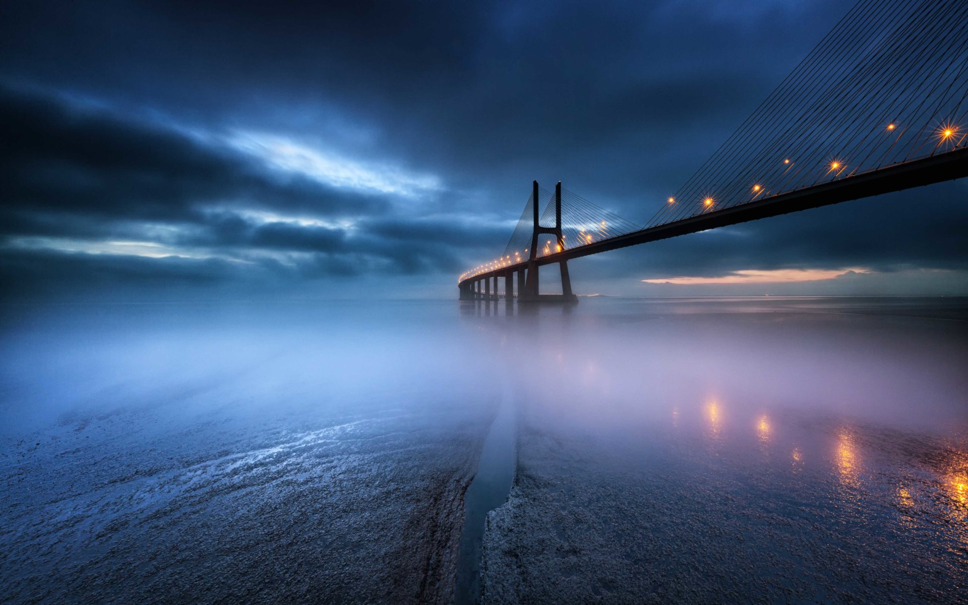 Download Cloud Sky Lake Fog Night Bridge Man Made Vasco Da Gama Bridge HD Wallpaper by Marco Lemos
