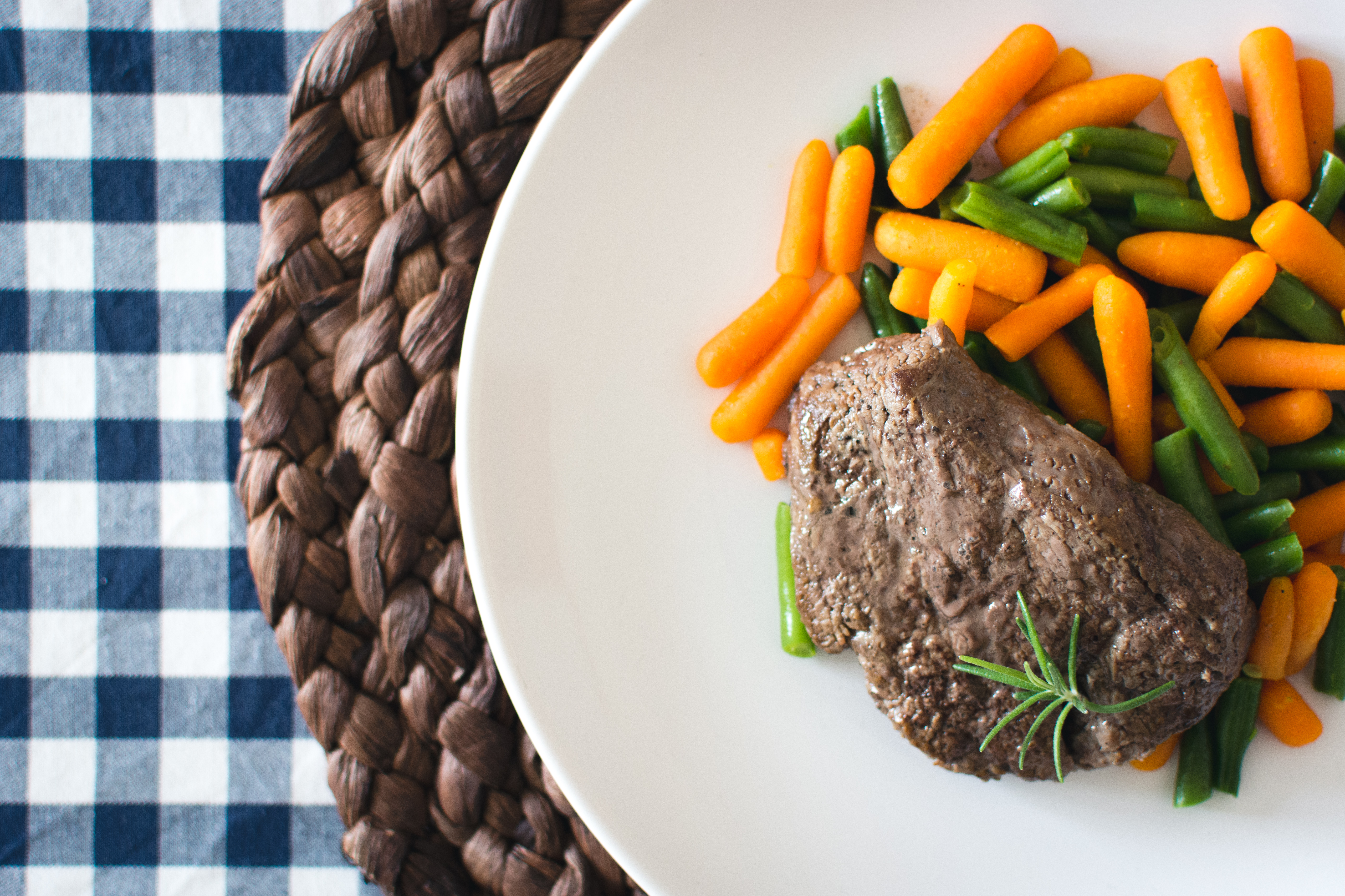 Beef steak with mini carrots and green beans by Jakub Kapusnak