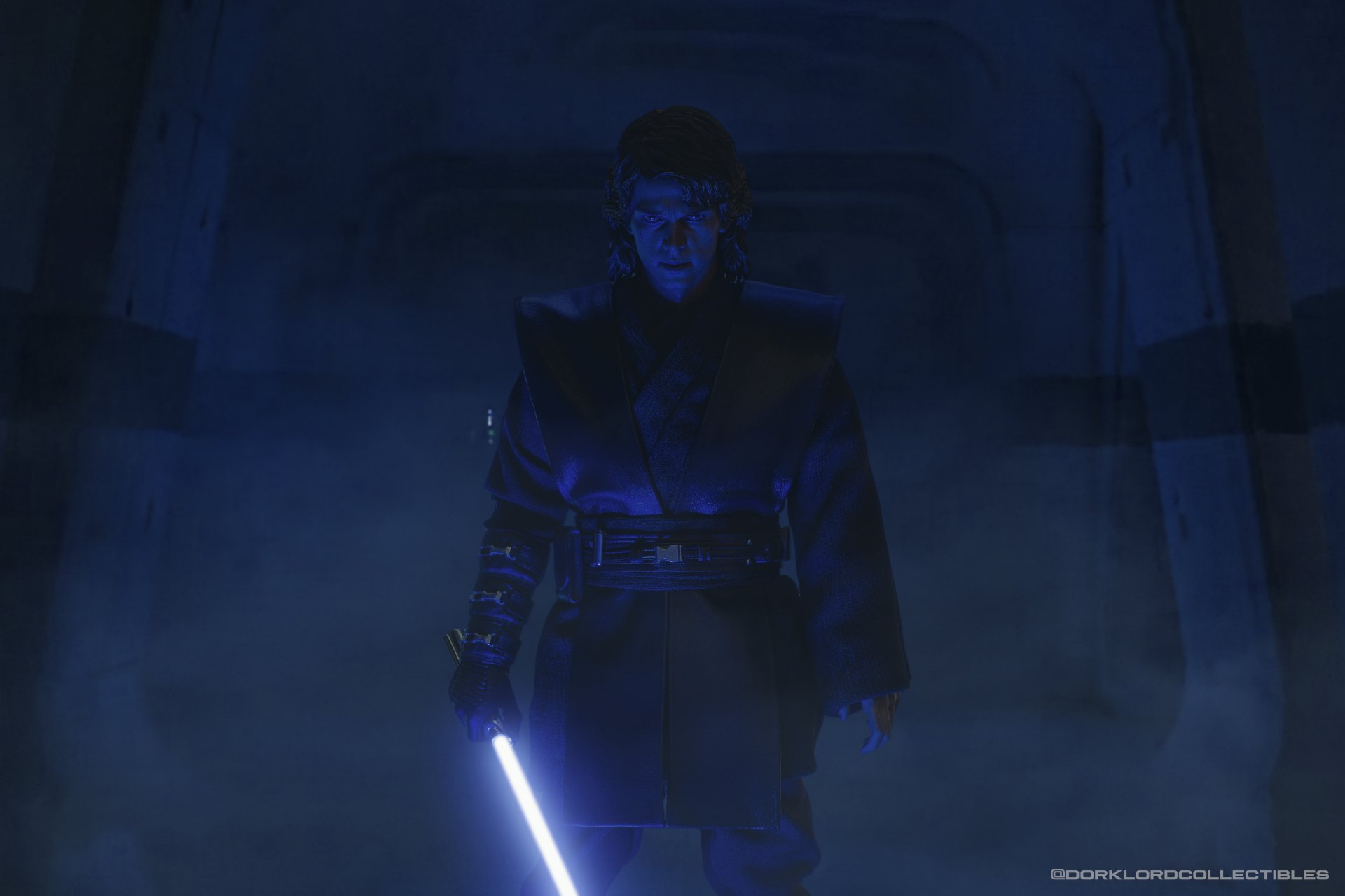 5K Ultra HD desktop wallpaper of a man-made Anakin Skywalker toy figurine holding a blue lightsaber, standing in a blue-lit, mist-filled corridor.