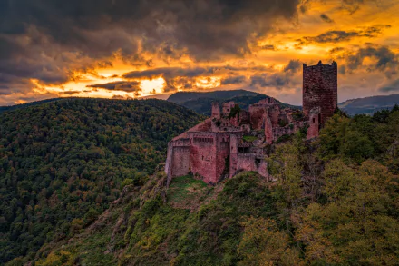 Sunset over the man-made Rappoltsweiler castle ruins in Alsace, France, surrounded by forested hills, captured in stunning 8K Ultra HD detail.