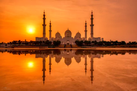 Sheikh Zayed Grand Mosque, Abu Dhabi at sunset: Islamic religious architecture with domes and minarets mirrored on calm water — HD desktop wallpaper.