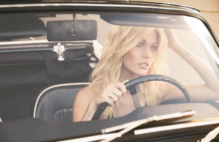 Blonde actress at the wheel of a vintage car, gazing thoughtfully — HD PC desktop wallpaper.