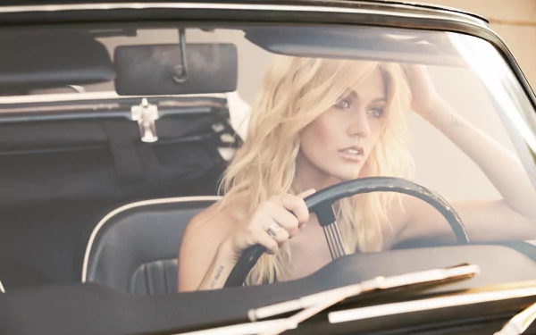 Blonde actress at the wheel of a vintage car, gazing thoughtfully — HD PC desktop wallpaper.