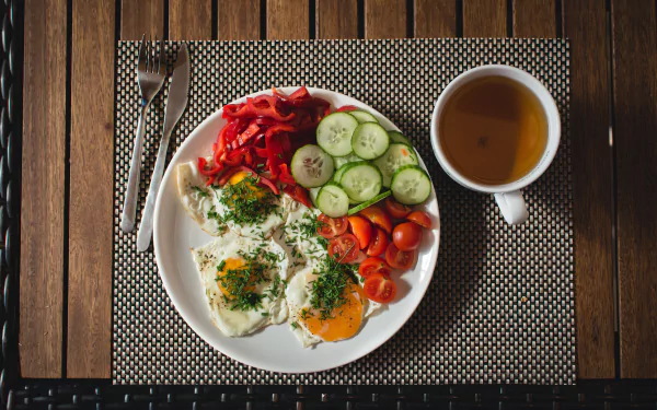  Paleo breakfast eggs with vegetables outside by Jakub Kapusnak