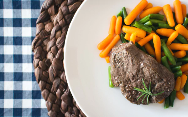  Beef steak with mini carrots and green beans by Jakub Kapusnak