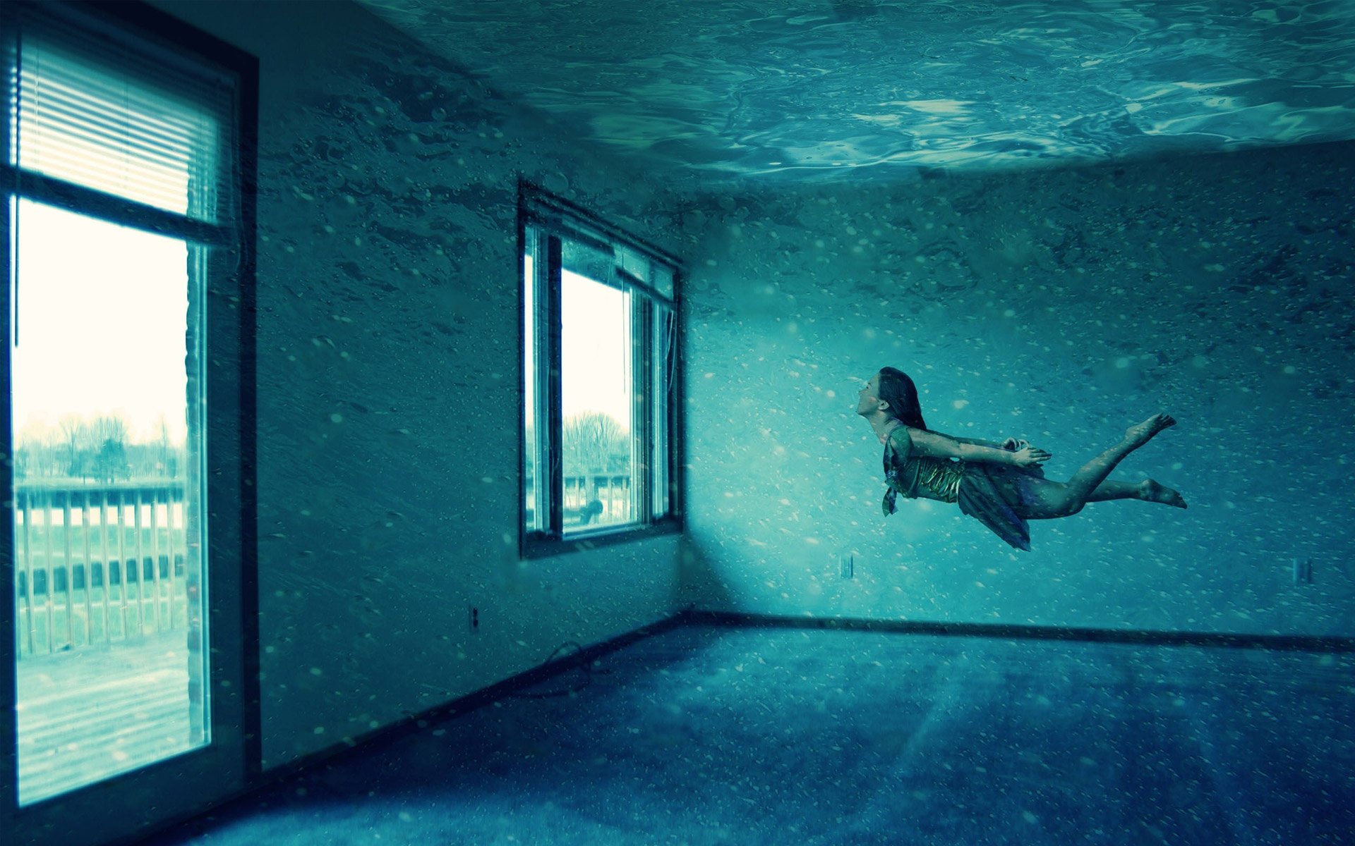 Artistic HD PC desktop wallpaper featuring a dimly lit, empty room with textured walls and a person floating horizontally near a window, creating a surreal atmosphere.
