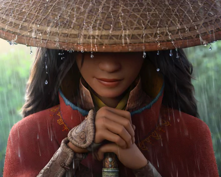 Raya from the movie Raya and the Last Dragon stands in the rain with a woven hat, hands clasped, featured in this HD PC desktop wallpaper and background.