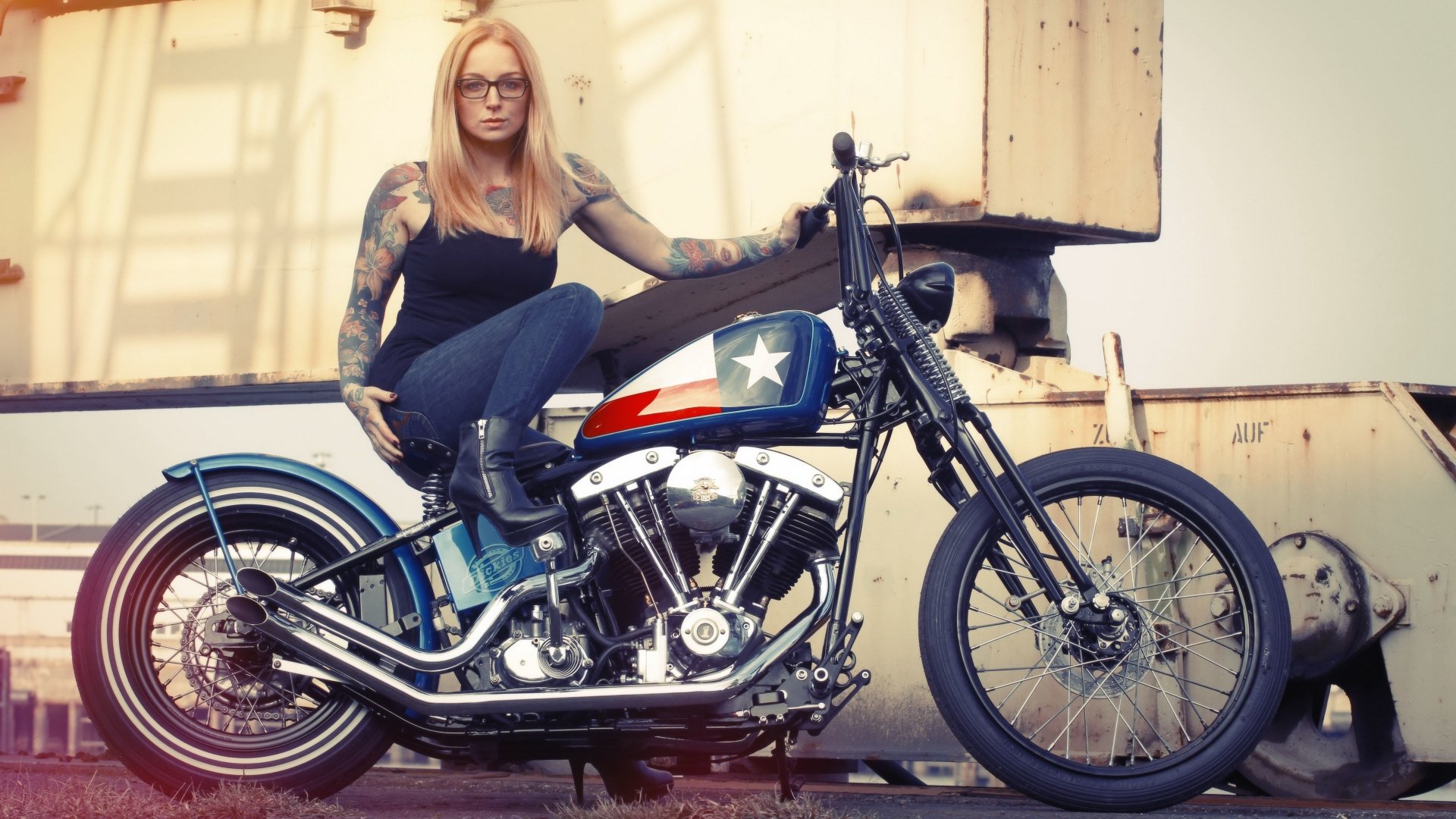 Blonde tattooed woman in glasses perched on a vintage motorcycle — Girls & Motorcycles 4K Ultra HD PC desktop wallpaper and background