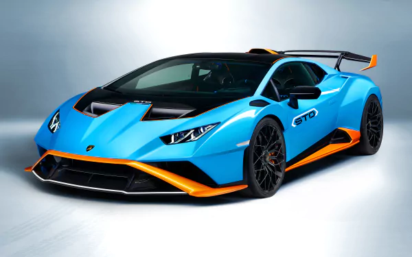 A blue Lamborghini Huracán STO supercar with orange accents displayed as a 4K Ultra HD PC desktop wallpaper and background.