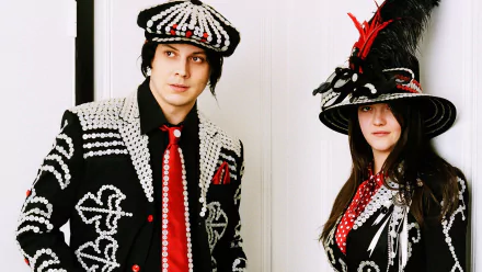 HD wallpaper featuring members of The White Stripes in patterned black-and-white attire with red accents.
