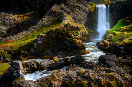 A stunning 4K Ultra HD image of Dynjandi waterfall cascading down cliffs in Iceland’s vibrant natural landscape.